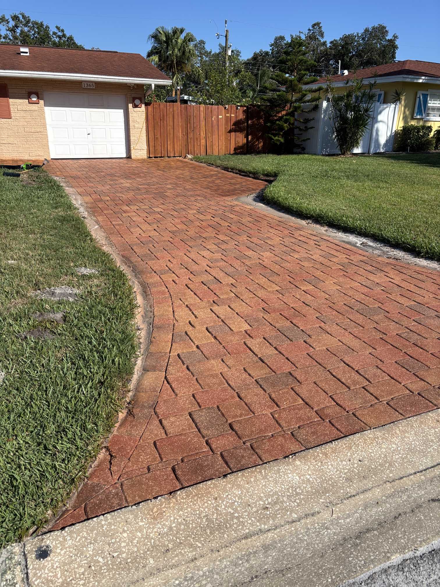 Curved walkway detail after Brick Red paver stain and sealing in Clearwater, FL