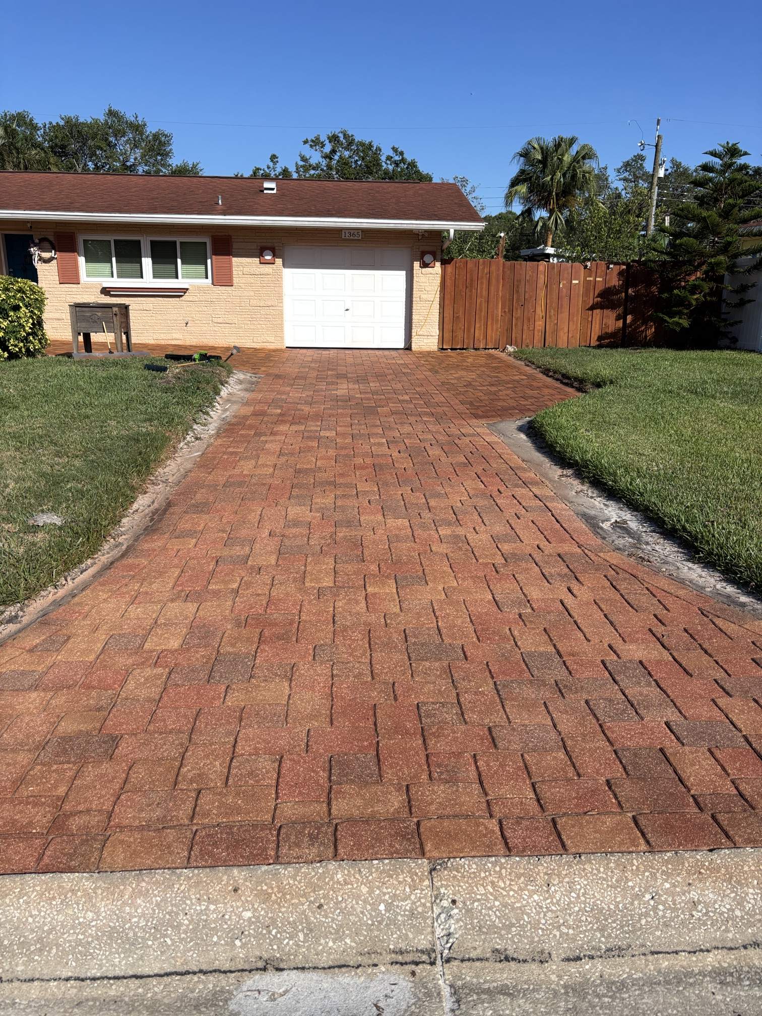House and driveway view after Brick Red paver stain and paver sealing in Clearwater, FL