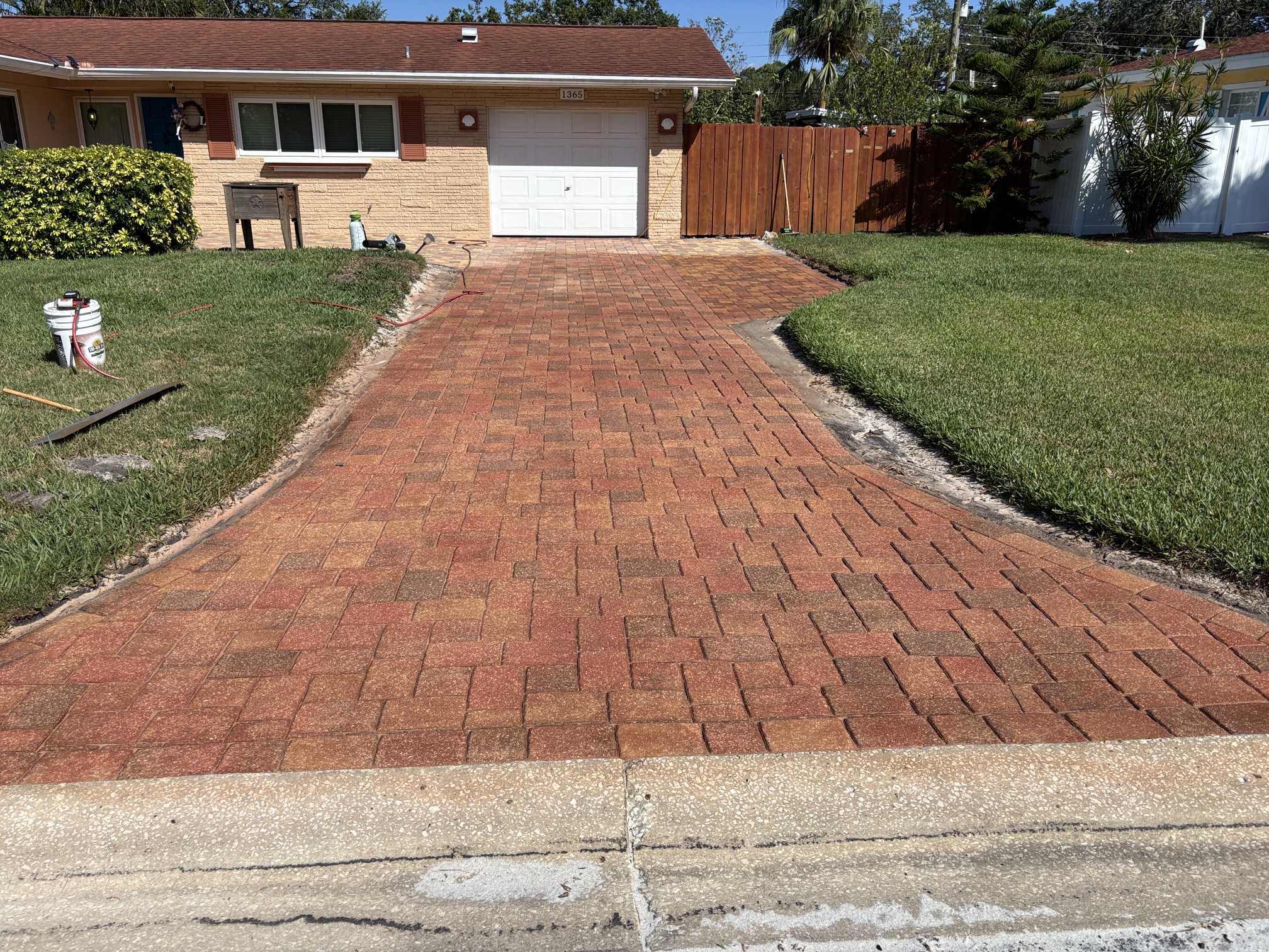 Wide view of the driveway after Brick Red paver stain and paver sealing in Clearwater, FL