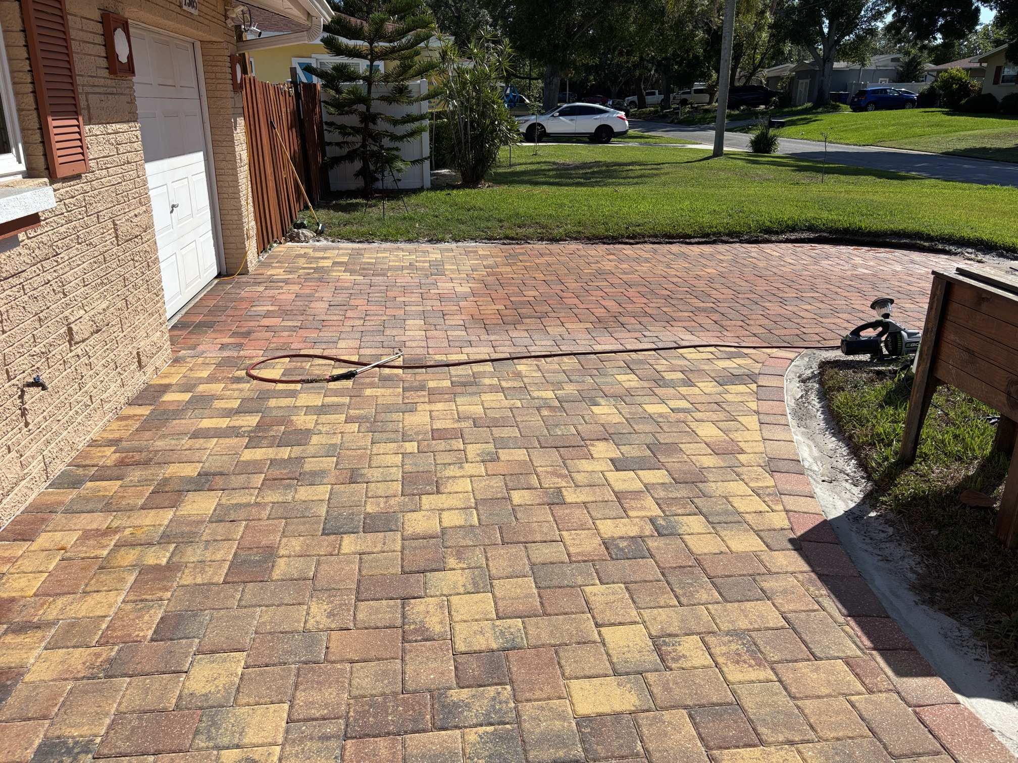 Close-up of faded pavers near the garage before paver tinting in Clearwater, FL