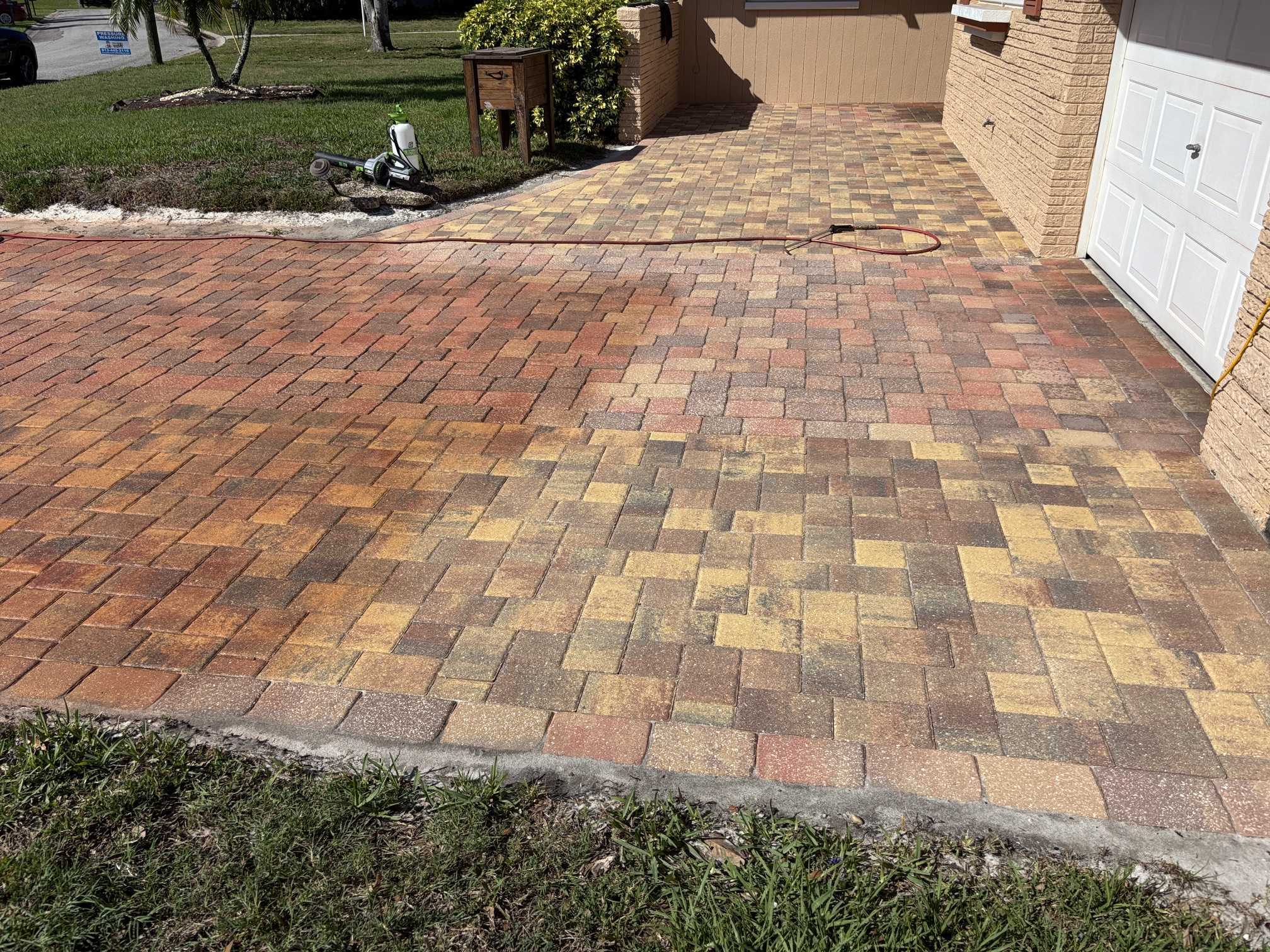 Paver driveway near the garage before cleaning and paver tinting in Clearwater, FL