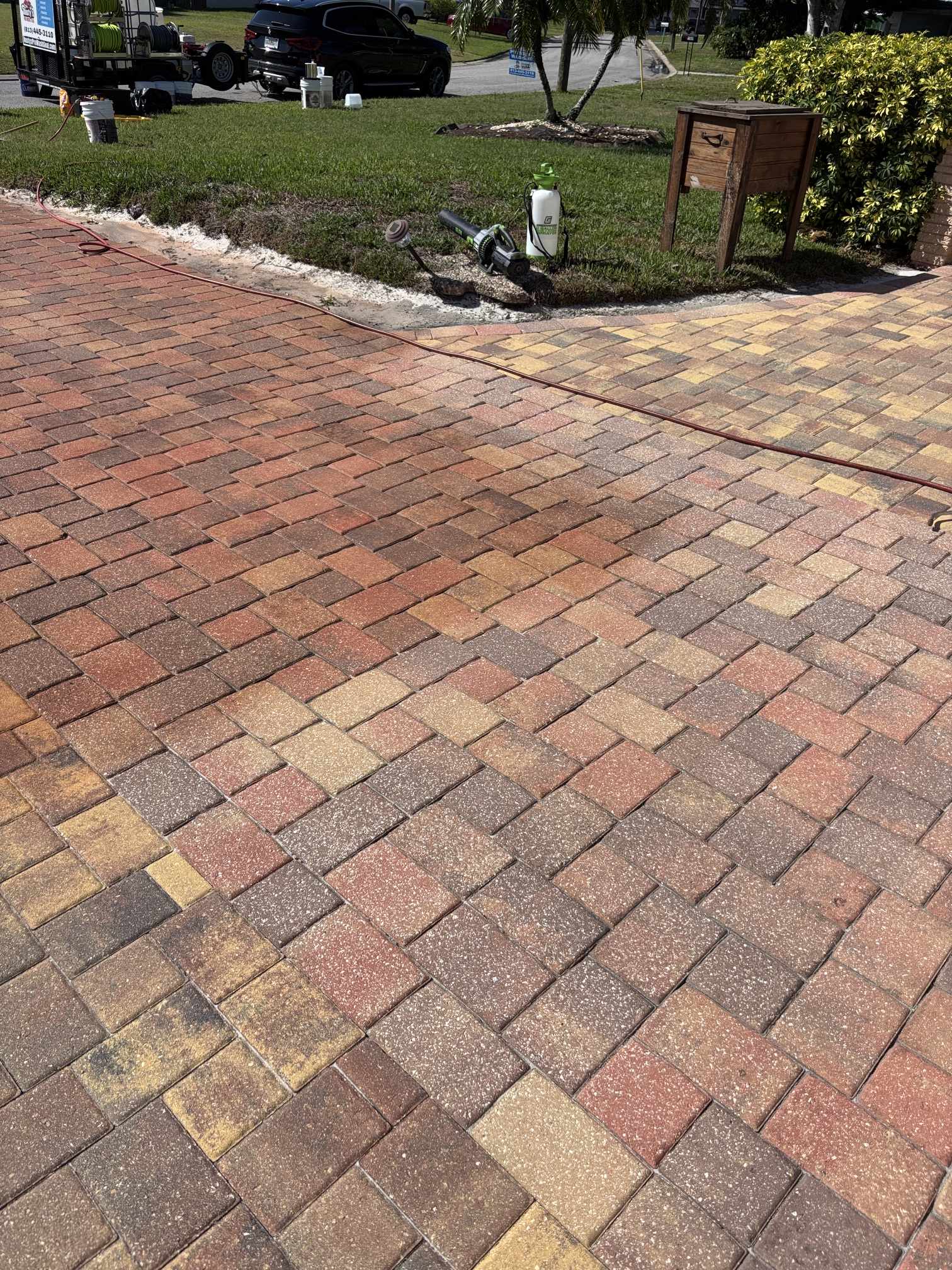 Faded paver driveway before paver tinting, side angle view, Clearwater, FL