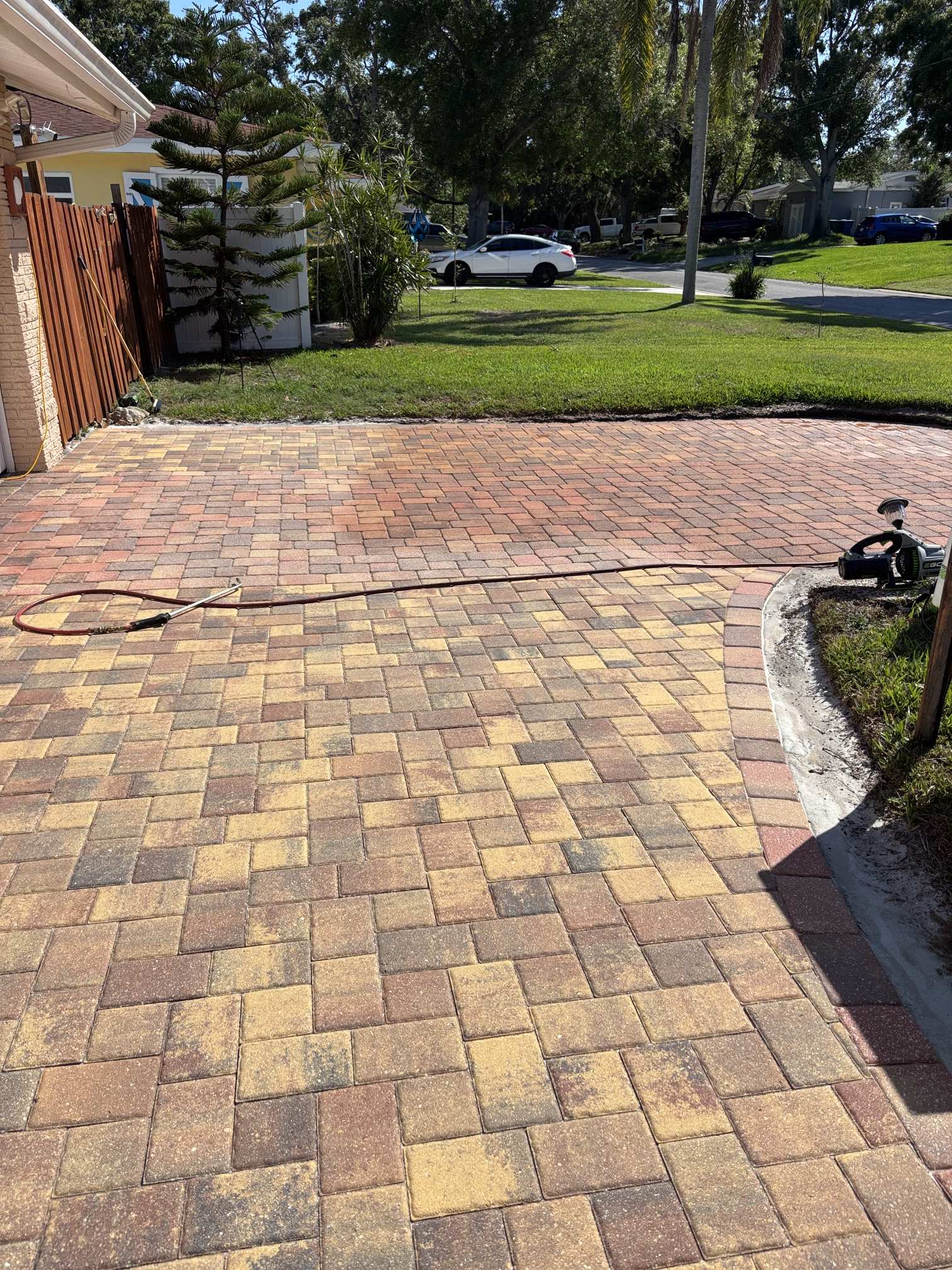 Wide view of a faded paver driveway before paver tinting in Clearwater, FL