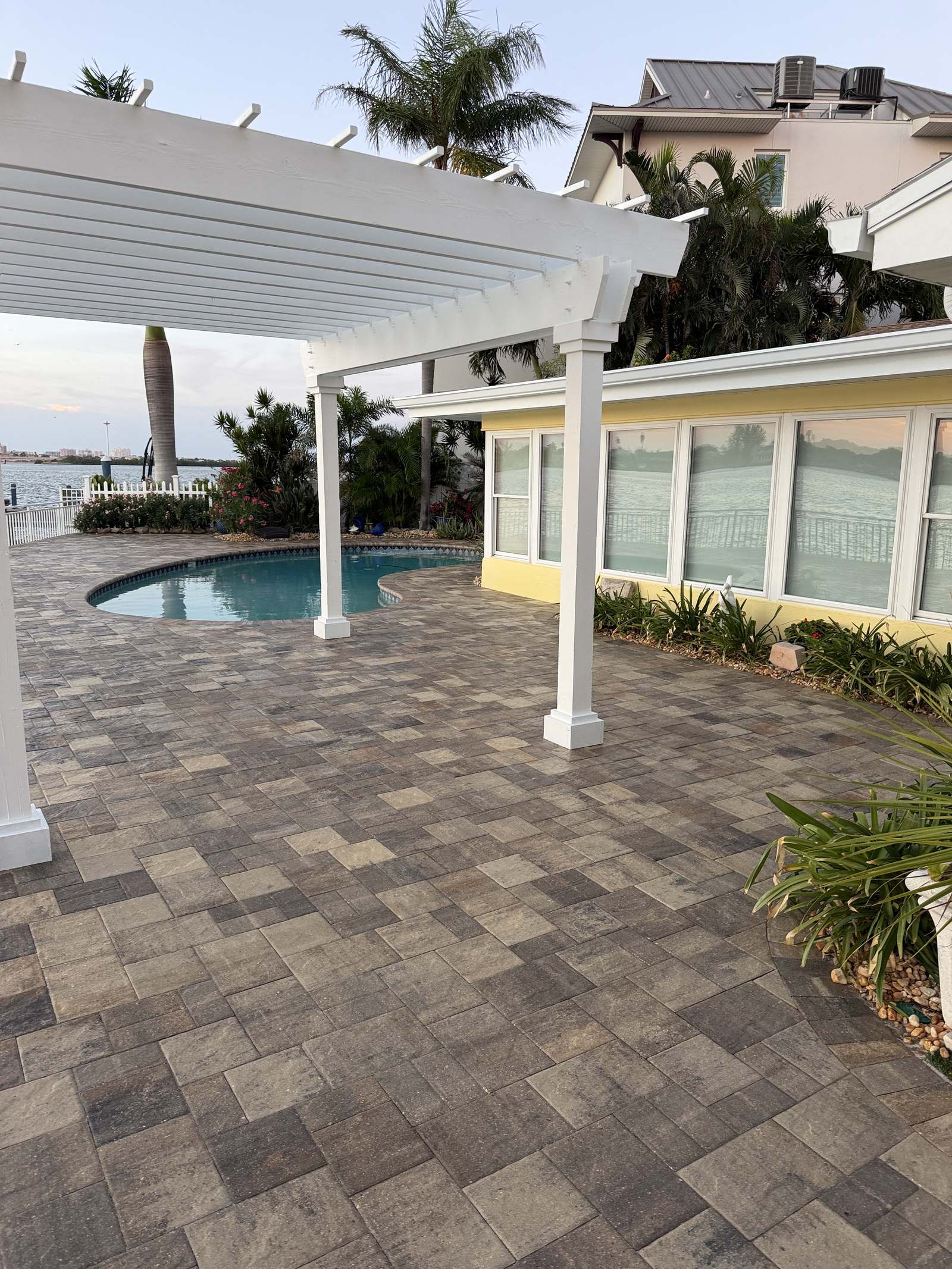 Sealed paver pool deck with pergola in Indian Rocks Beach, FL