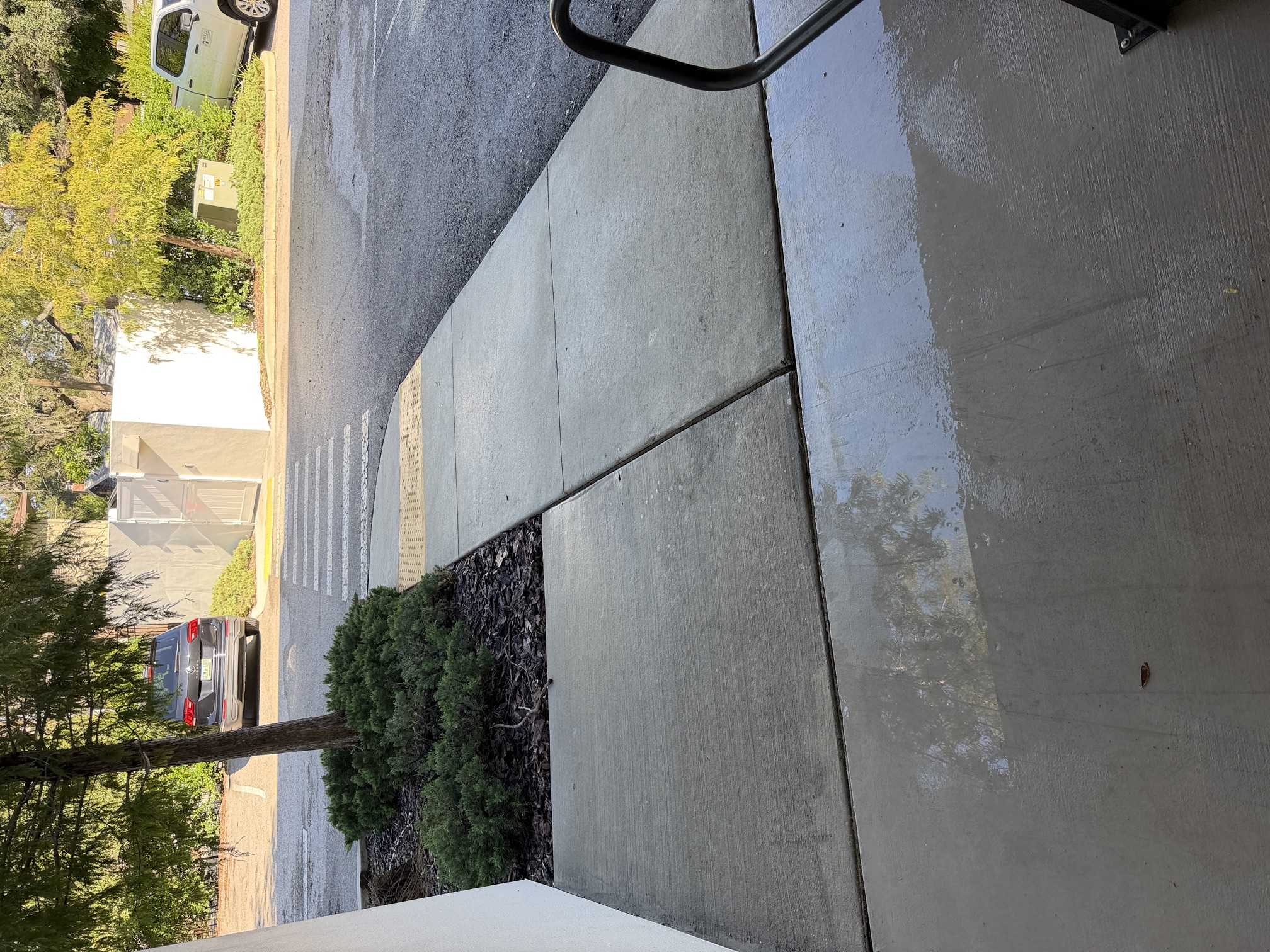After photo of a clean curved sidewalk near the parking area at an apartment community in Largo, FL