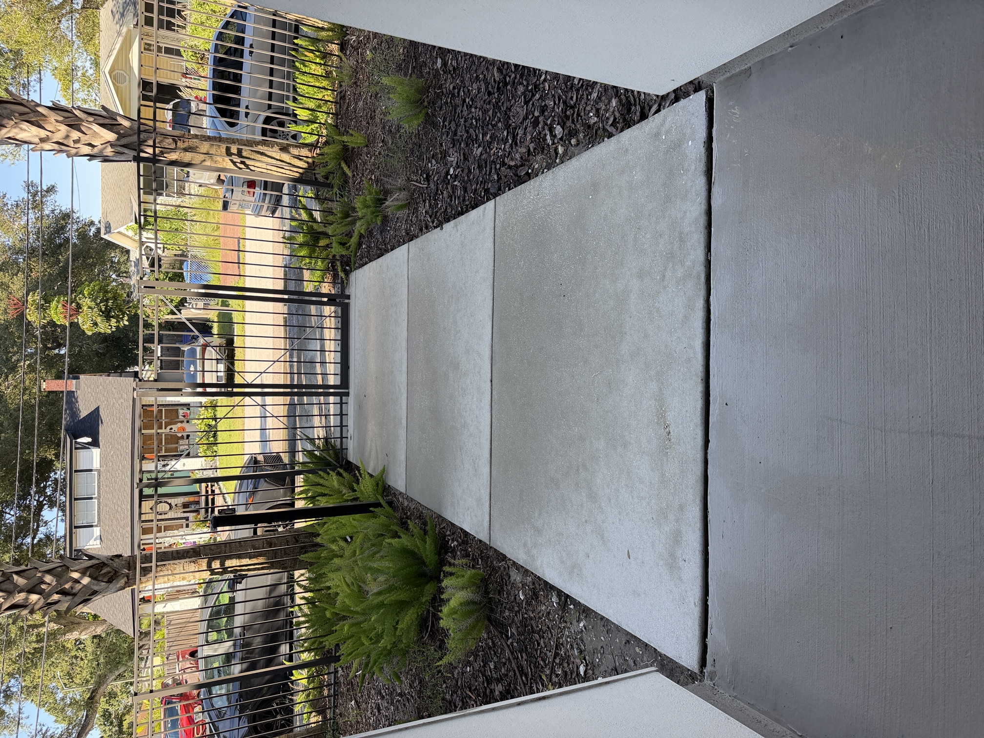 After photo of a clean entry sidewalk leading to the street gate at an apartment community in Largo, FL