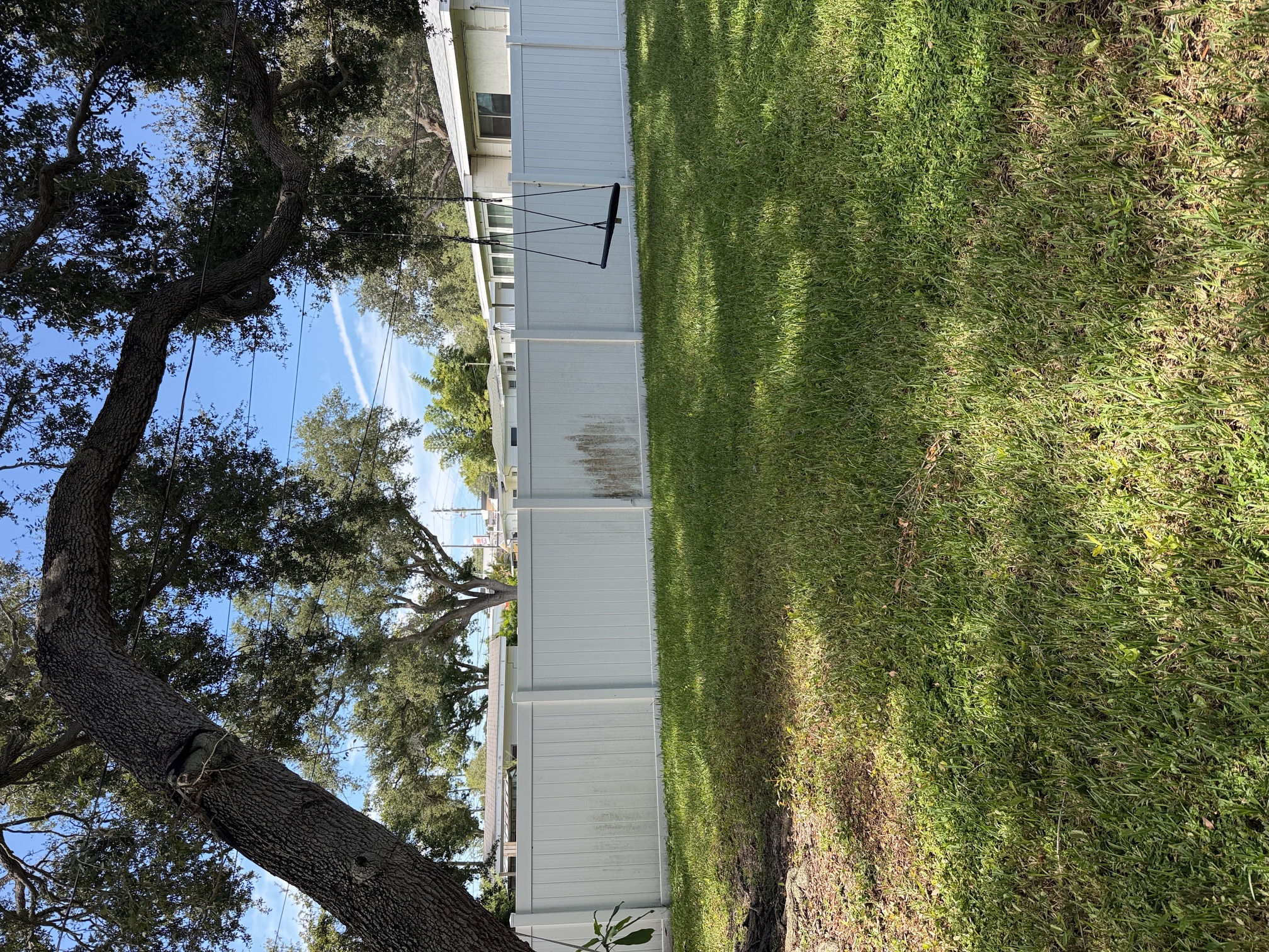 Before photo of a stained vinyl privacy fence in Largo, FL