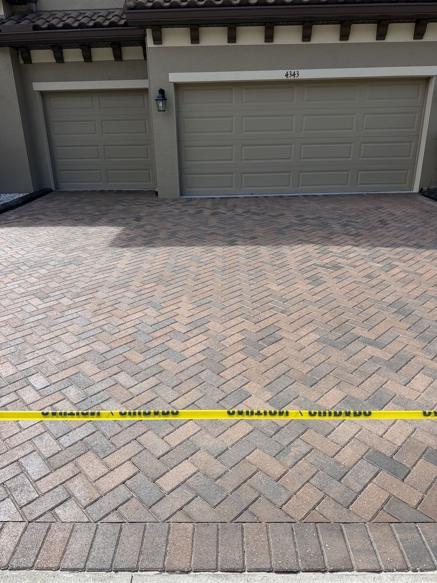 Close-up of sealed herringbone paver driveway at the first home in The Sanctuary, Brandon, FL