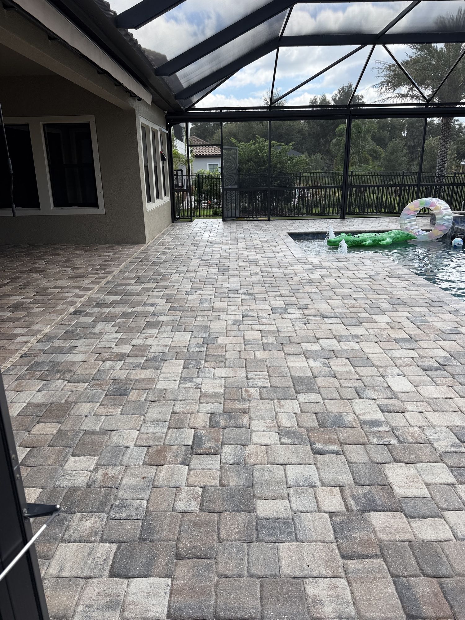 Sealed screened pool deck pavers at the first home in The Sanctuary, Brandon, FL