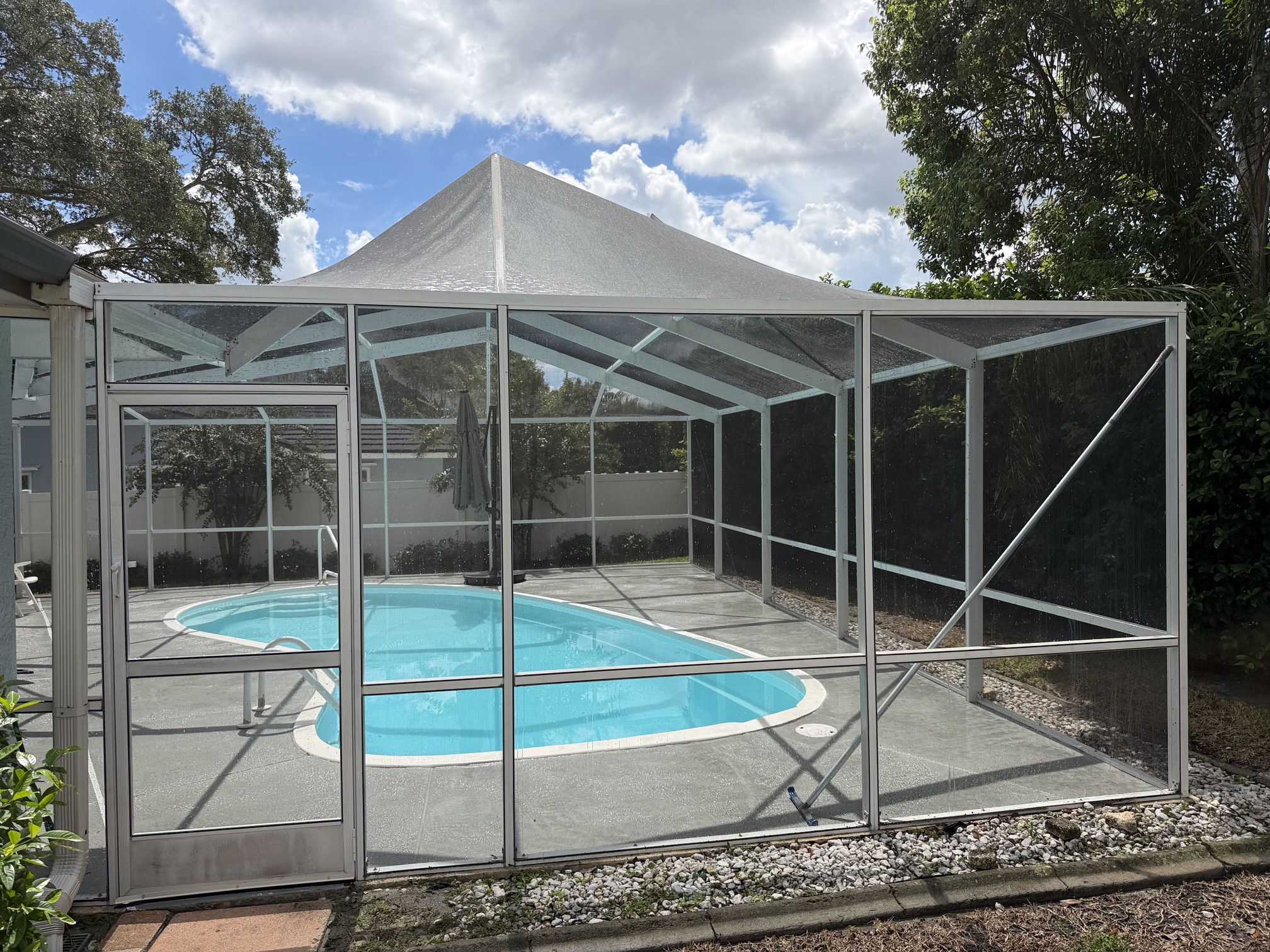 After photo of a cleaned screened pool cage enclosure in Palm Harbor, FL