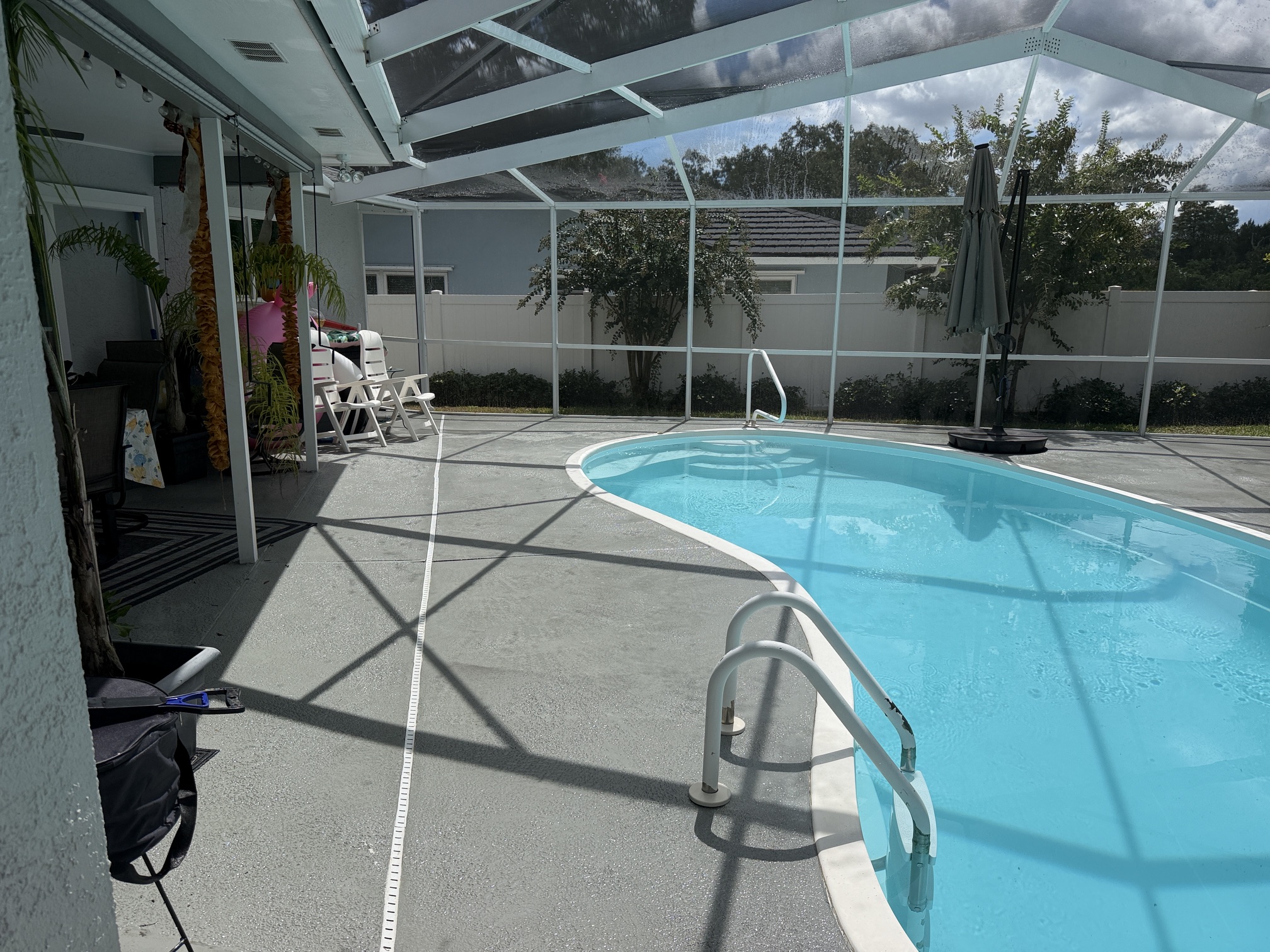 After photo of a cleaned pool deck inside a screened enclosure in Palm Harbor, FL