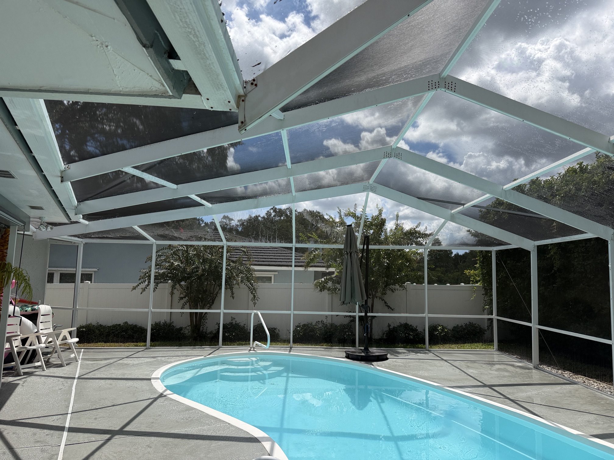 After photo of cleaned pool cage roof panels and pool area in Palm Harbor, FL