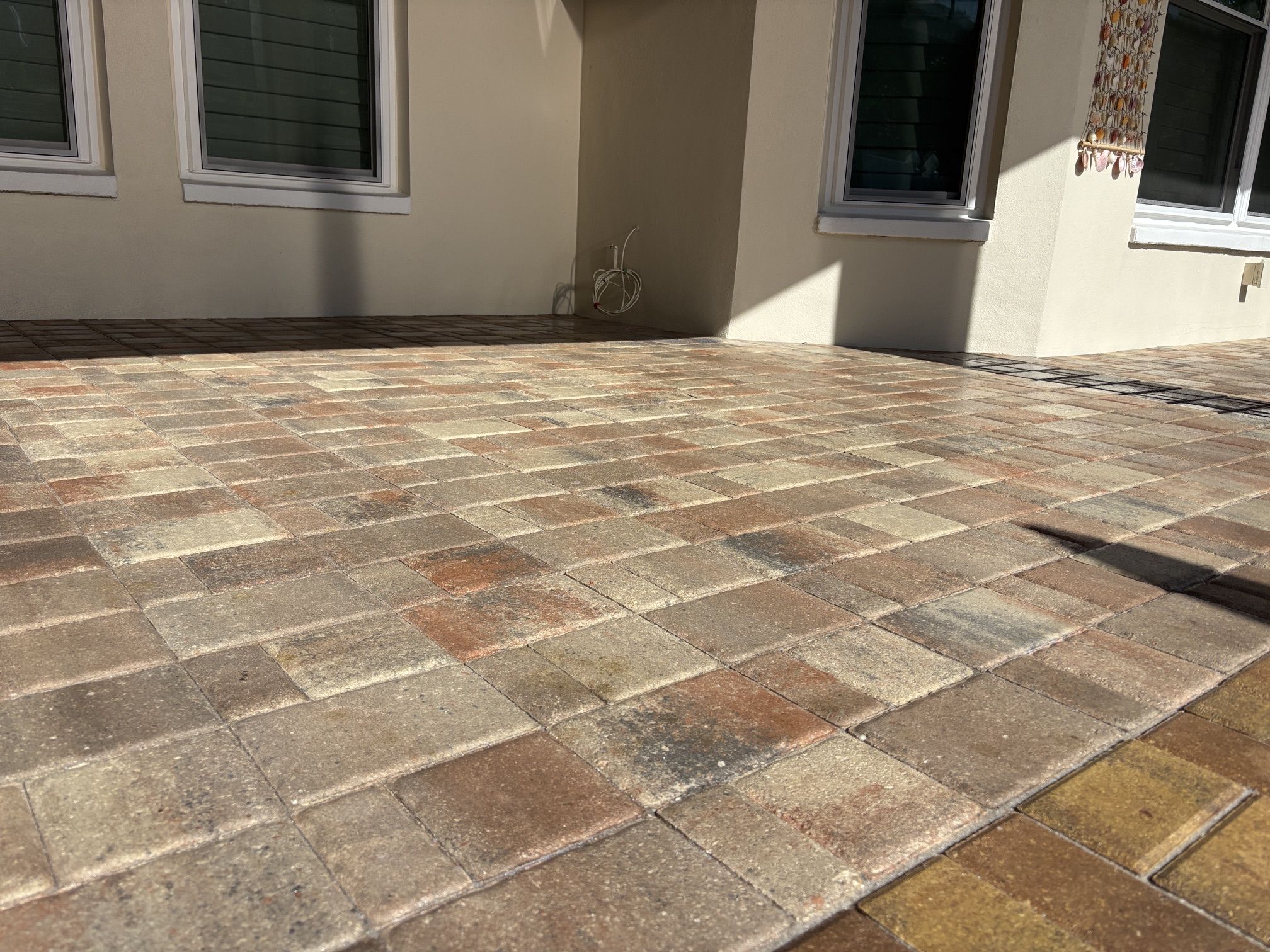 Wide view of a lanai after paver sealing with a wet look sealer in the Traditions of Seminole, FL